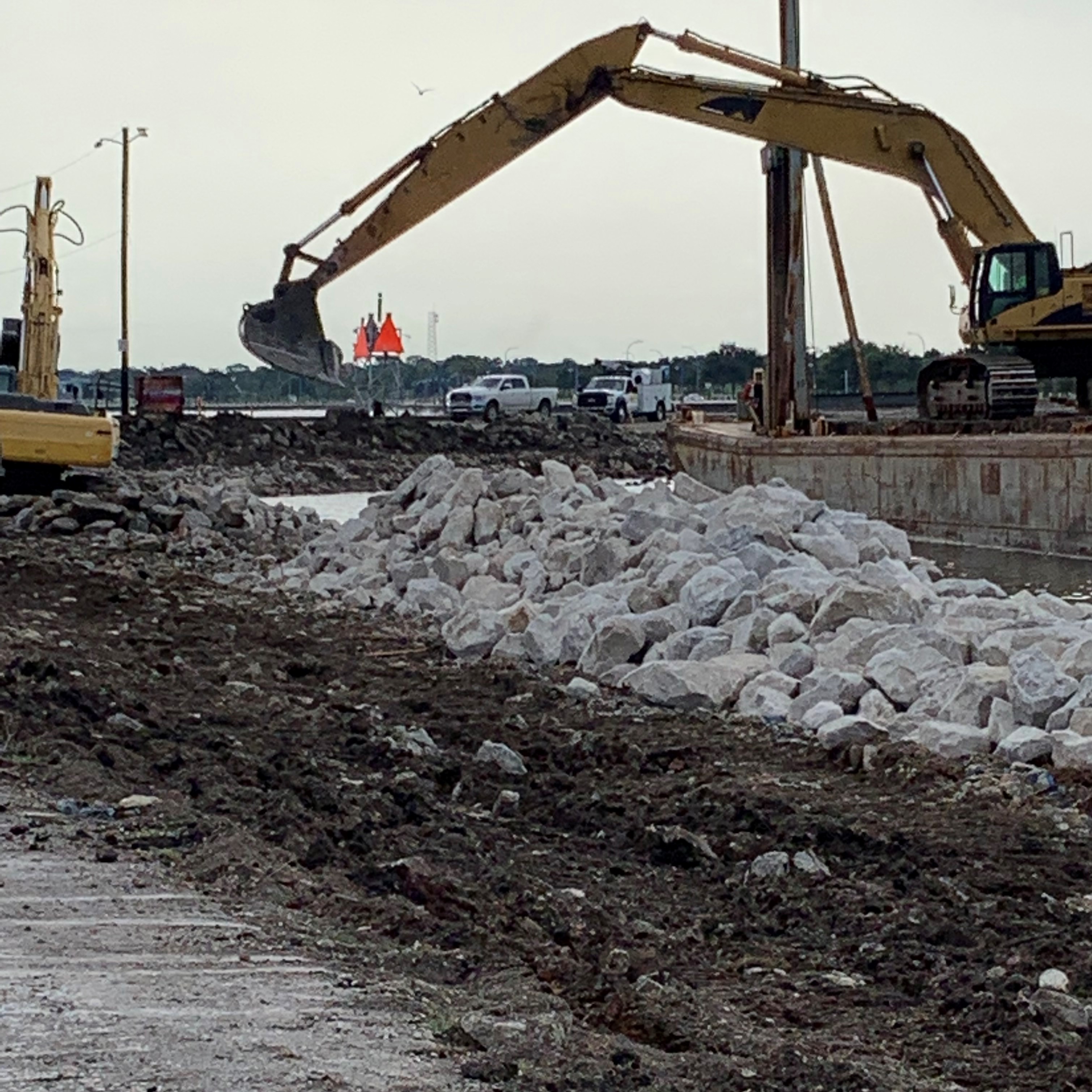 CREWS BEGIN TESTING THE DURABILITY OF THE RETAINING WALL ON THE BREAKWATER DRIVE PROJECT